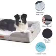 A black and white dog lies on a gray cushioned pet bed with feature callouts on the right, including waterproof liner, zipper design, non-slip bottom, and memory foam.
